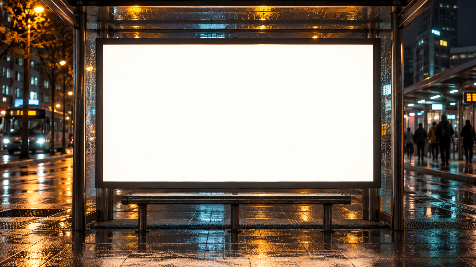 Illuminated blank ad display at a rainy city transit stop