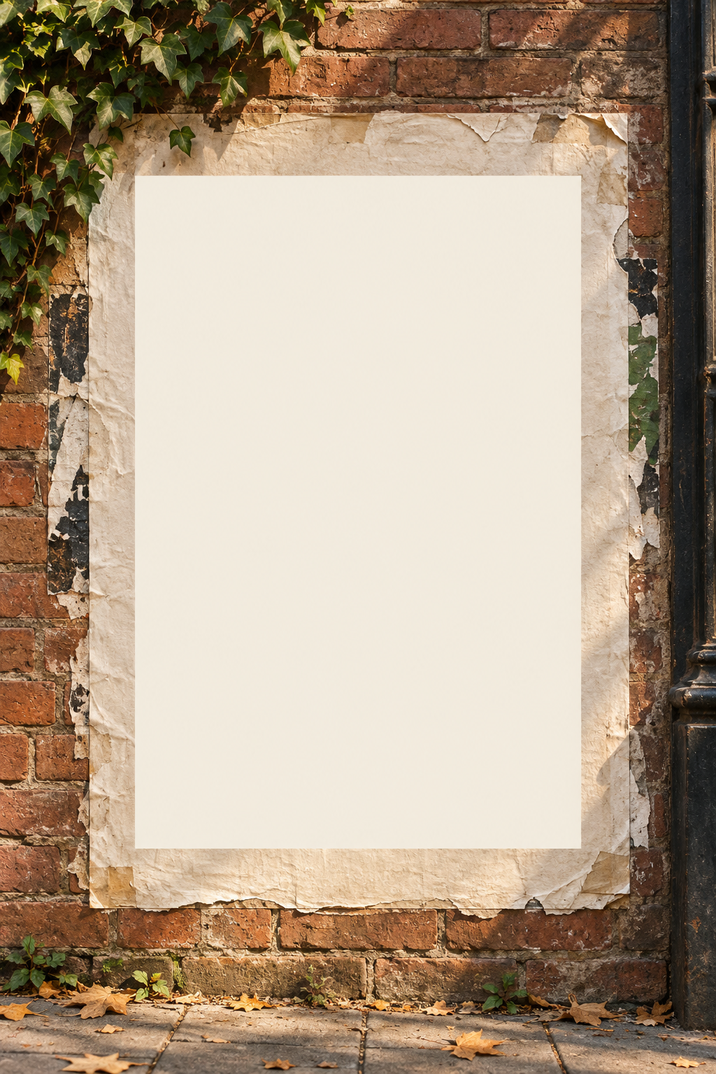 Blank pasted poster on a warm brick wall with ivy and weathered paper edges